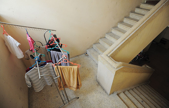 Tại nhiều chung cư, một số cư dân tận dụng cầu thang bộ làm chỗ để đồ và phơi quần áo. Ảnh: Dũng Minh
