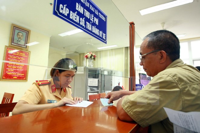Công an quận Hai Bà Trưng, Hà Nội làm thủ tục đăng ký đăng ký xe máy cho người dân. (Ảnh: Doãn Tấn/TTXVN)