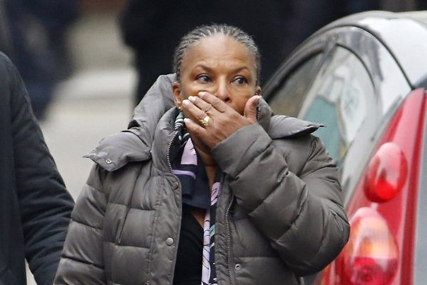 French Justice Minister Christiane Taubira reacts outside of the headquarters of the French satirical newspaper Charlie Hebdo in Paris on January 7, 2015, after armed gunmen stormed the offices leaving twekve dead. At least 12 people were killed when gunmen armed with Kalashnikovs and a rocket-launcher opened fire in the offices of French satirical weekly Charlie Hebdo on January 7. AFP PHOTO / KENZO TRIBOUILLARD