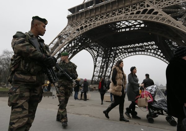 French soldiers patrol near the Eiffel Tower in Paris as part of the highest level of 